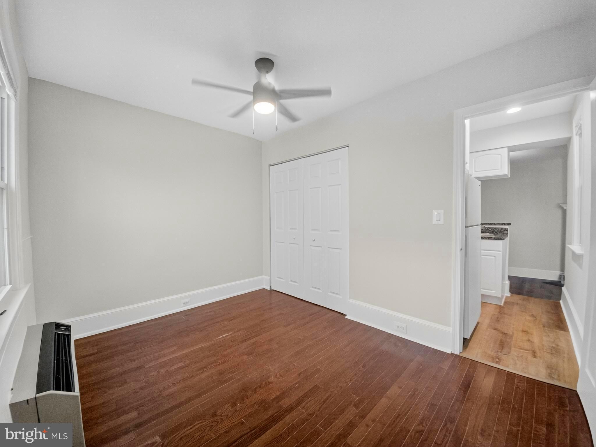 1765 U Street Northwest, Unit 2 Washington, DC 20009 - Photo 12 of 16 an empty room with wooden floor fan and windows