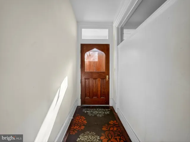 a view of hallway with wooden floor