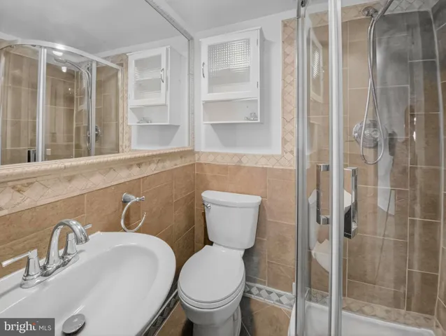 a bathroom with a toilet sink and shower