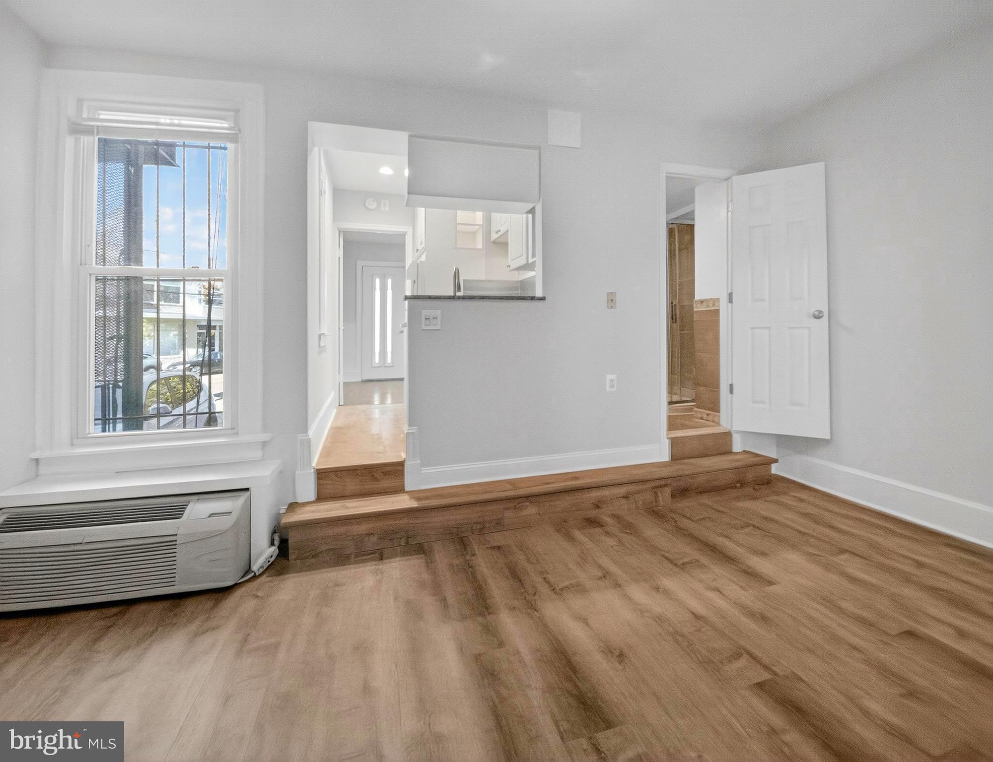 1765 U Street Northwest, Unit 2 Washington, DC 20009 - Photo 7 of 16 a view of empty room with wooden floor and fan