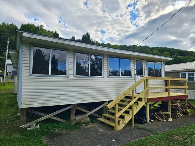 a view of a patio with table and chairs with wooden floor and fence