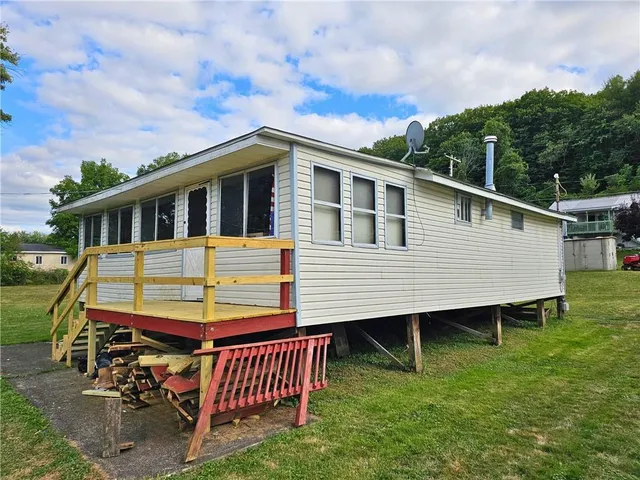 a view of a house with a yard and deck