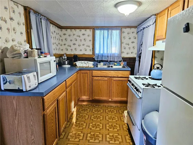 a kitchen with a sink appliances and cabinets
