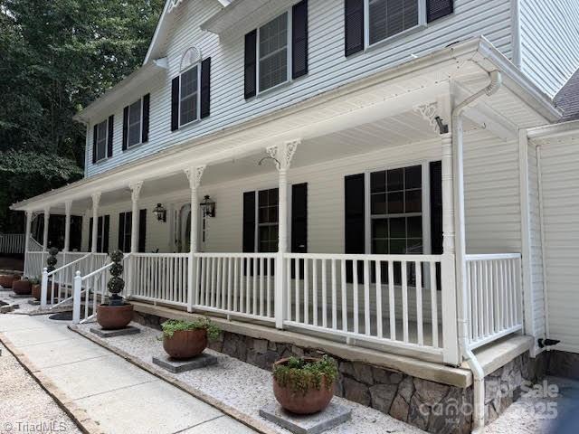 a view of a chair and table in the balcony