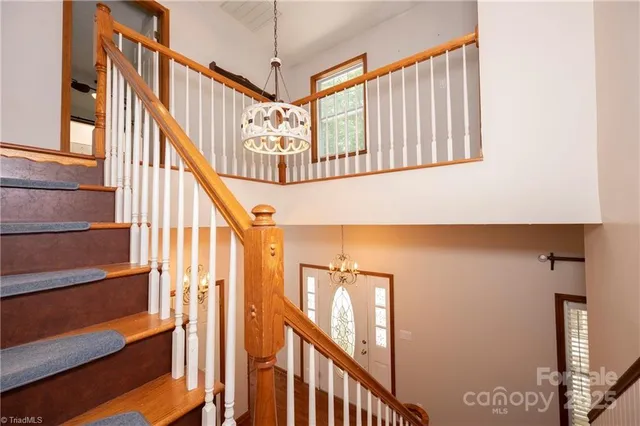 a view of a room with wooden floor fan and windows