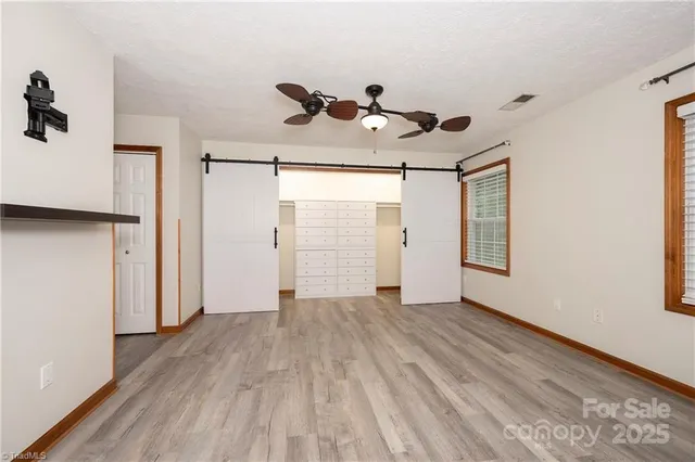 a bathroom with a granite countertop tub sink and mirror