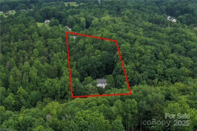 an aerial view of a house with yard swimming pool and outdoor seating