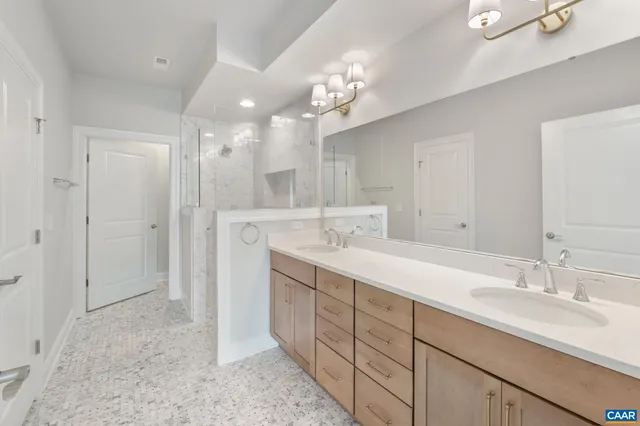 a bathroom with a sink double vanity and a mirror