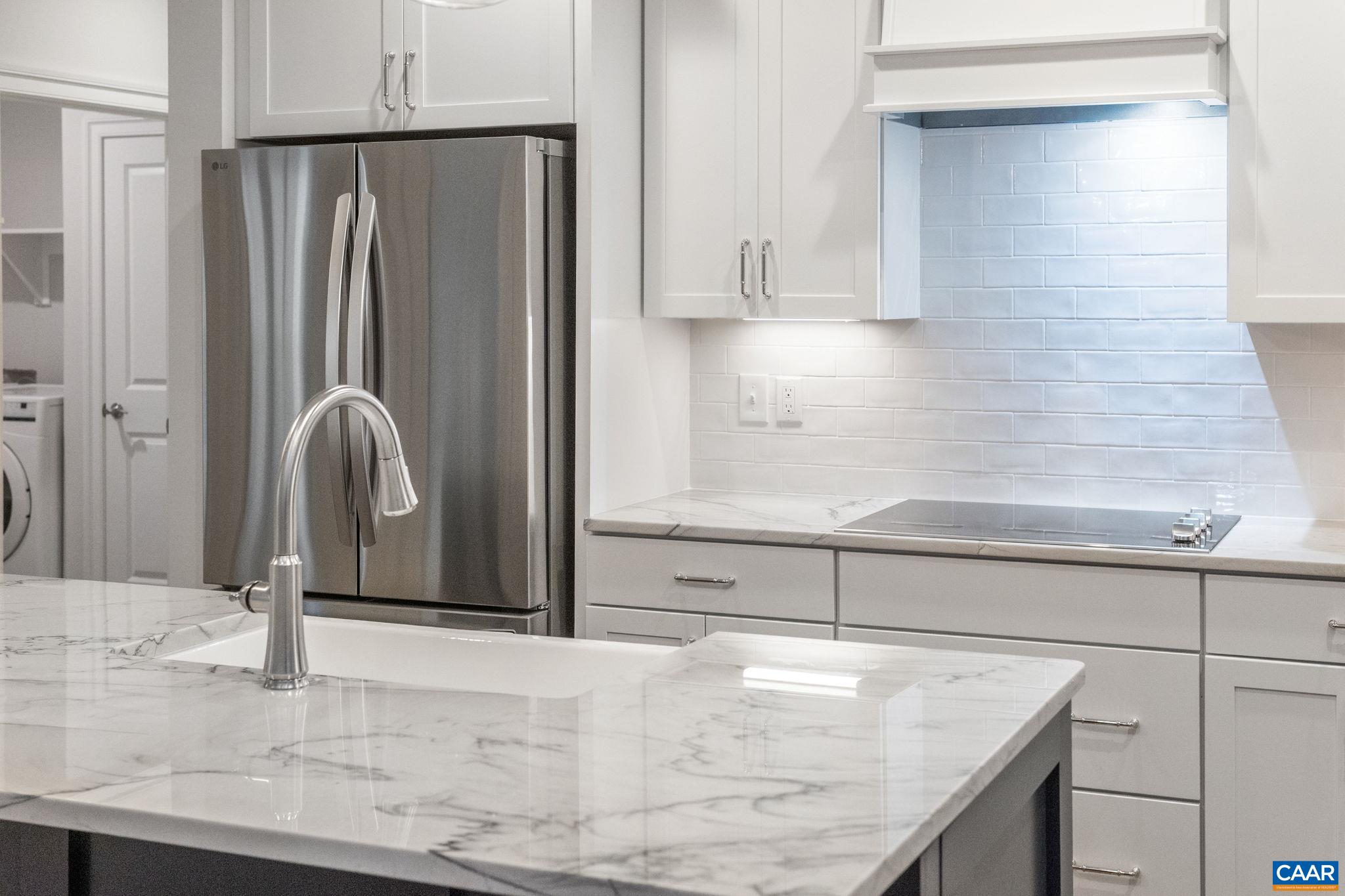 939 Addle Hill Road Crozet, VA 22932 - Photo 21 of 40 a kitchen with granite countertop a refrigerator and cabinets