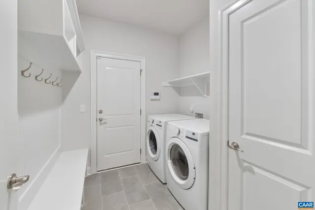 a view of a storage & utility room with dryer and washer