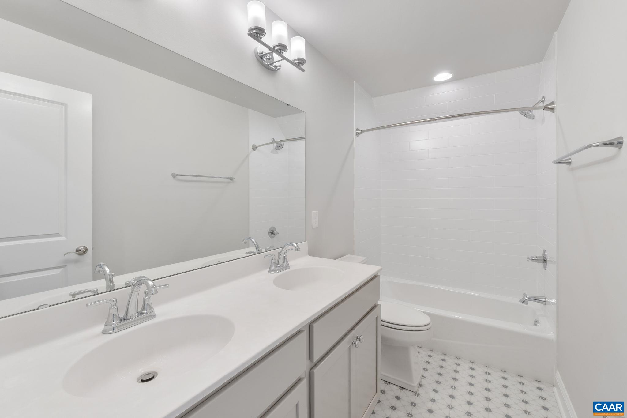 939 Addle Hill Road Crozet, VA 22932 - Photo 36 of 40 a bathroom with a sink a toilet and shower