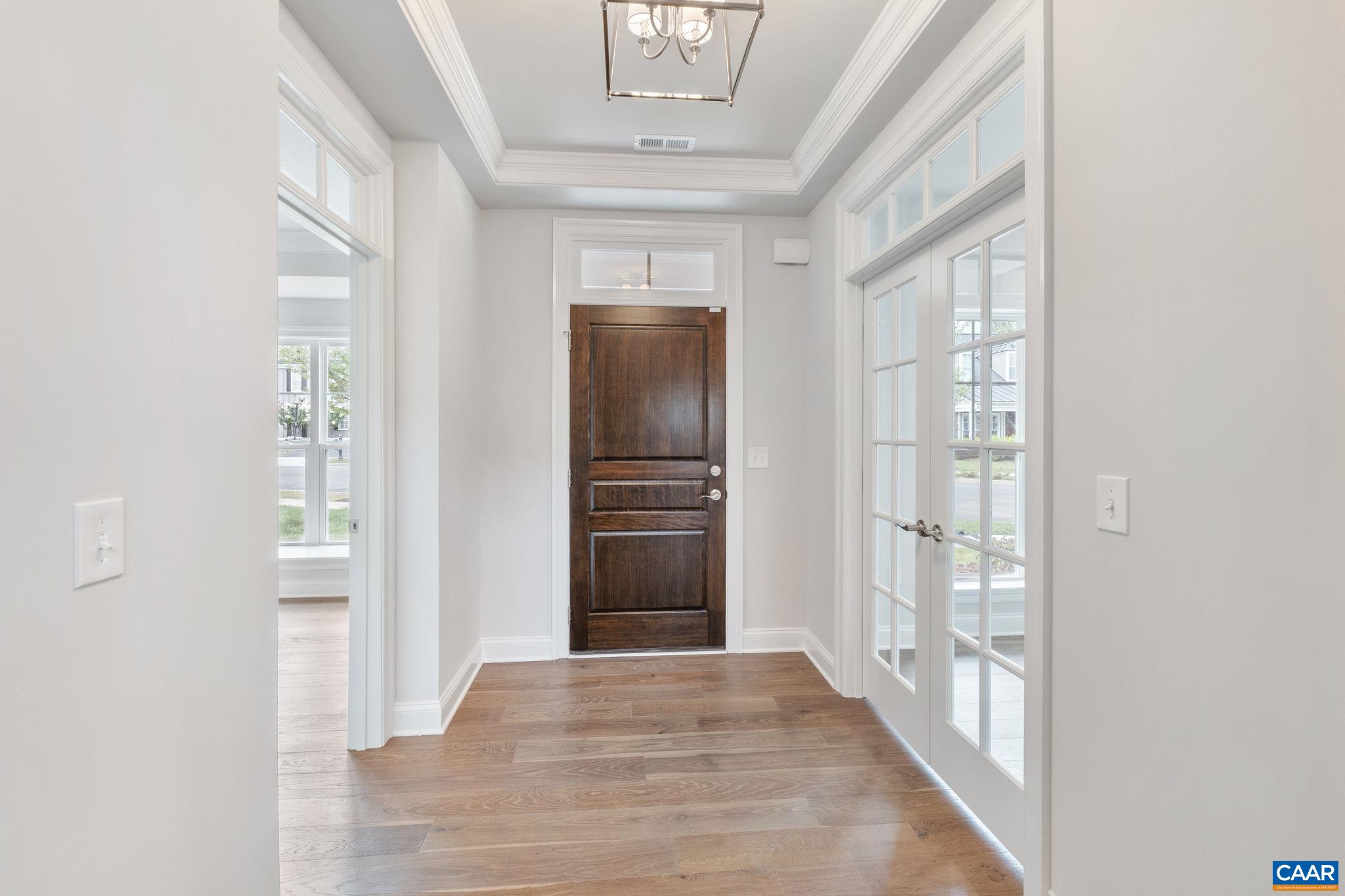939 Addle Hill Road Crozet, VA 22932 - Photo 10 of 40 a view of a hallway with wooden floor and a living room