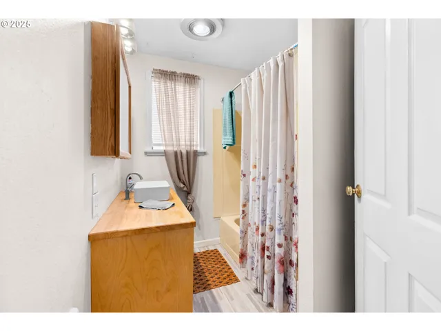 a bedroom with a bed and a dresser in it