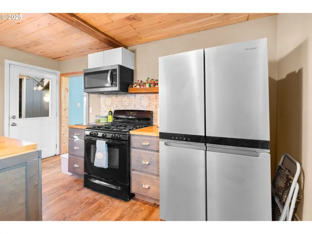 a kitchen with stainless steel appliances granite countertop a refrigerator and a stove