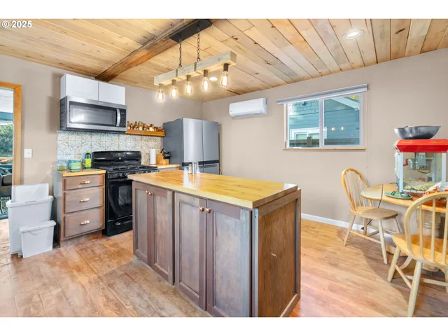 a kitchen with granite countertop a sink cabinets and stainless steel appliances