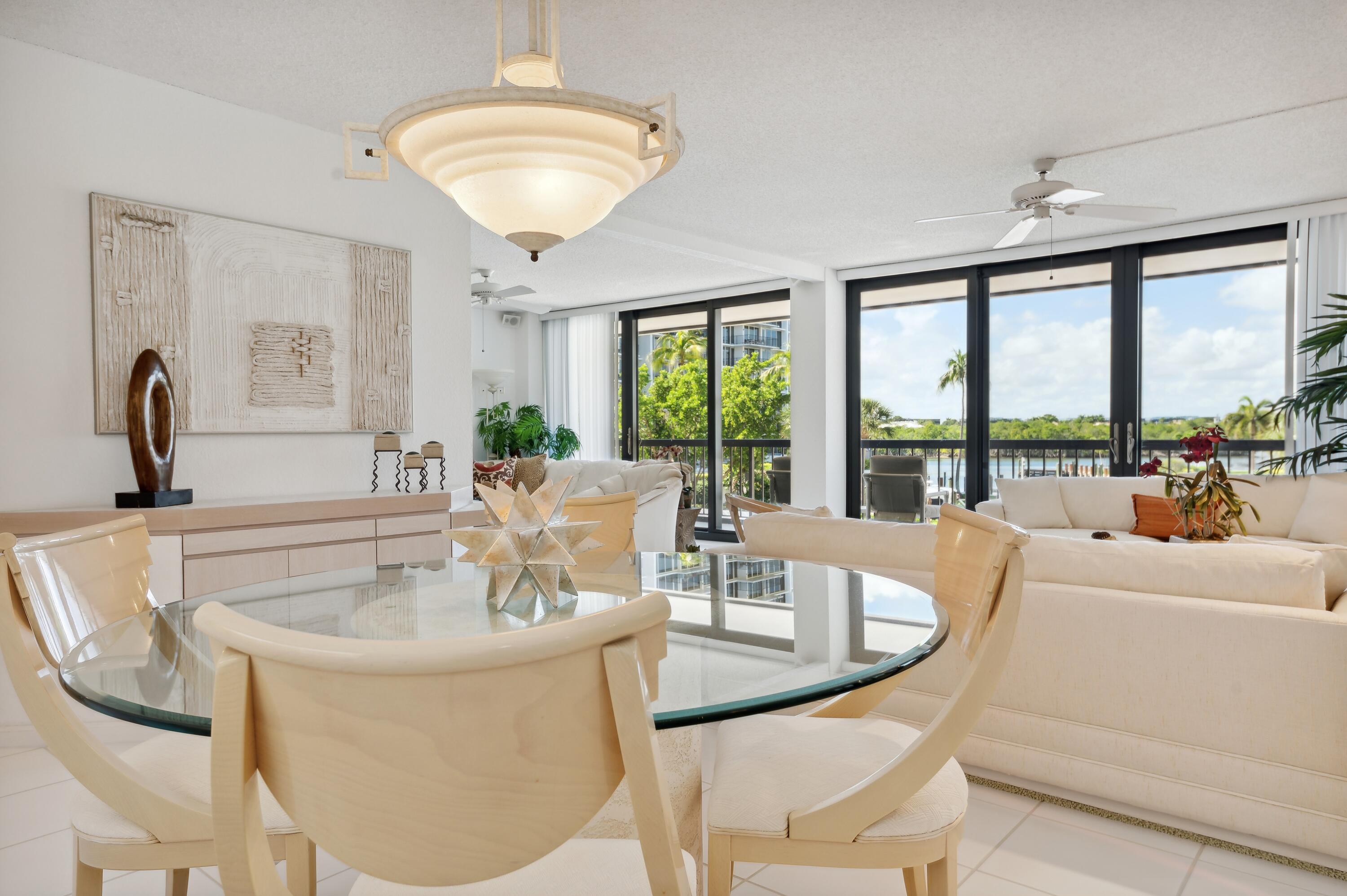 4748 South Ocean Boulevard, Unit 206 Highland Beach, FL 33487 - Photo 11 of 31 a dining room with furniture a large window and a chandelier