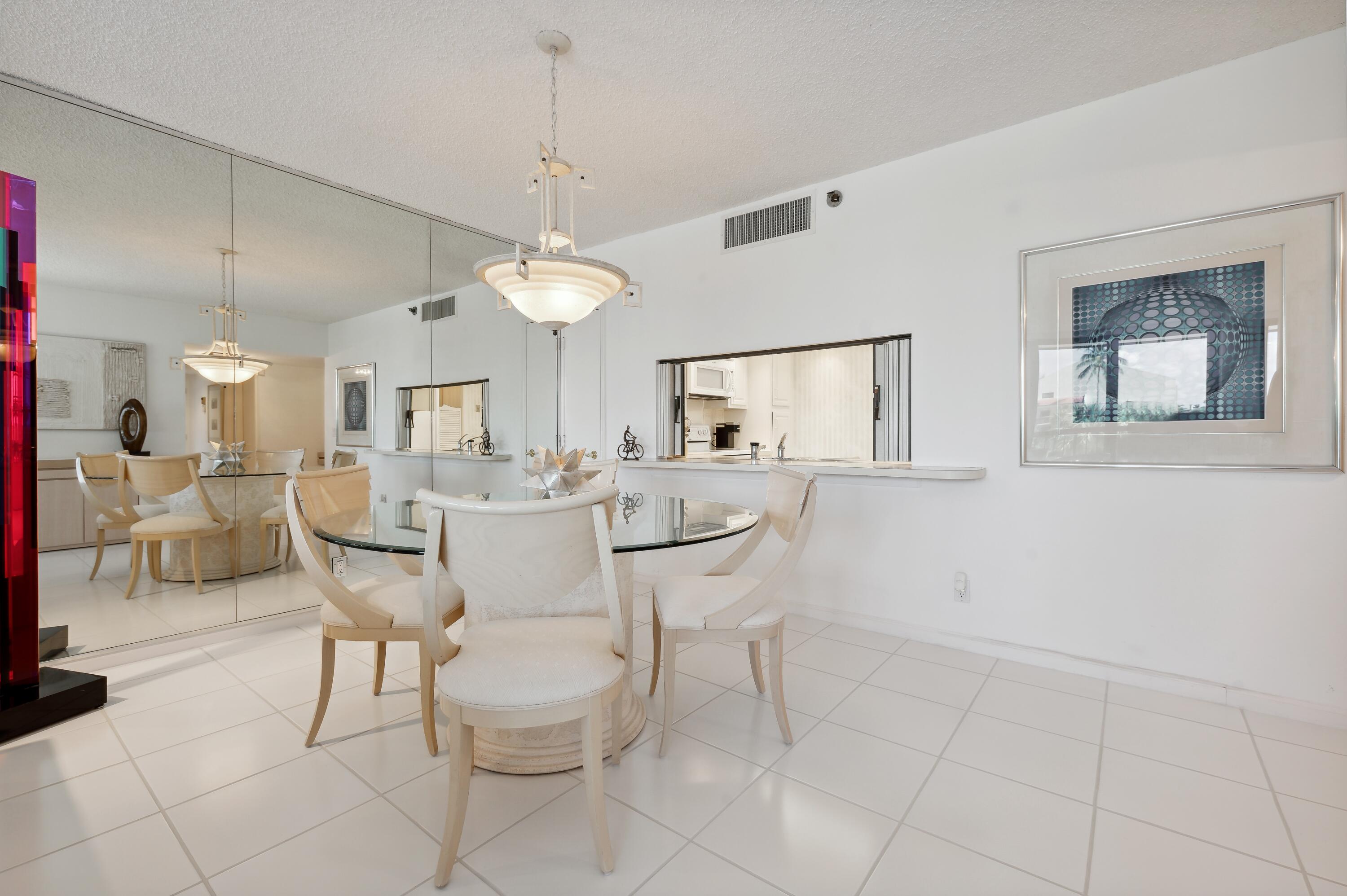 4748 South Ocean Boulevard, Unit 206 Highland Beach, FL 33487 - Photo 13 of 31 a view of a dining room with furniture and a chandelier fan