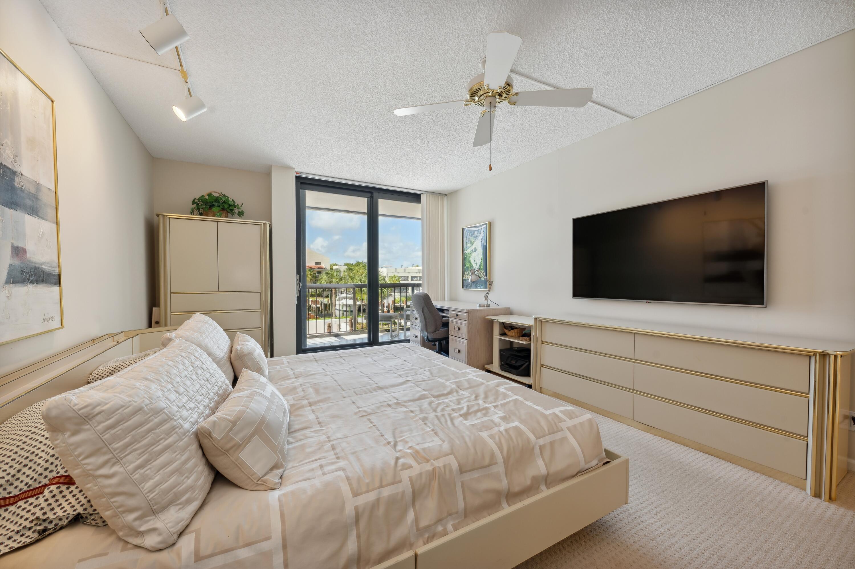 4748 South Ocean Boulevard, Unit 206 Highland Beach, FL 33487 - Photo 17 of 31 a bedroom with a bed tv and window