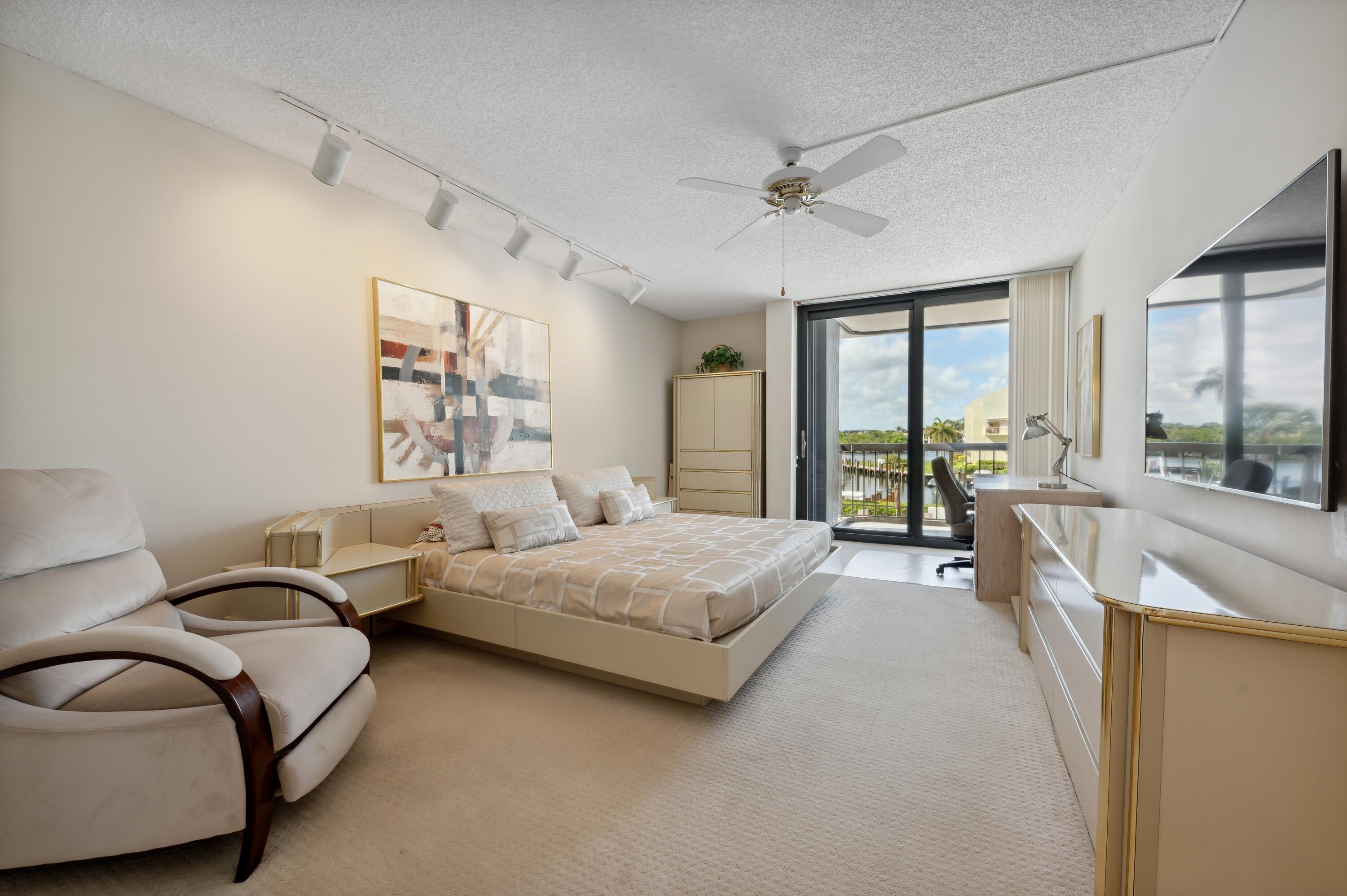 4748 South Ocean Boulevard, Unit 206 Highland Beach, FL 33487 - Photo 18 of 31 a spacious bedroom with a bed and glass windows