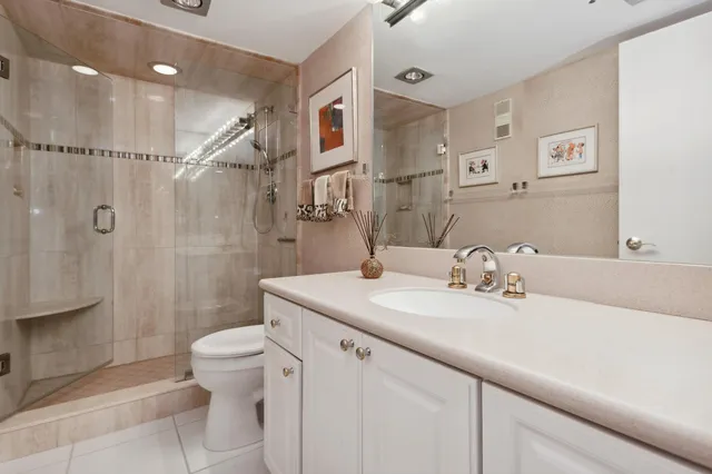 a spacious bathroom with a granite countertop sink mirror and a