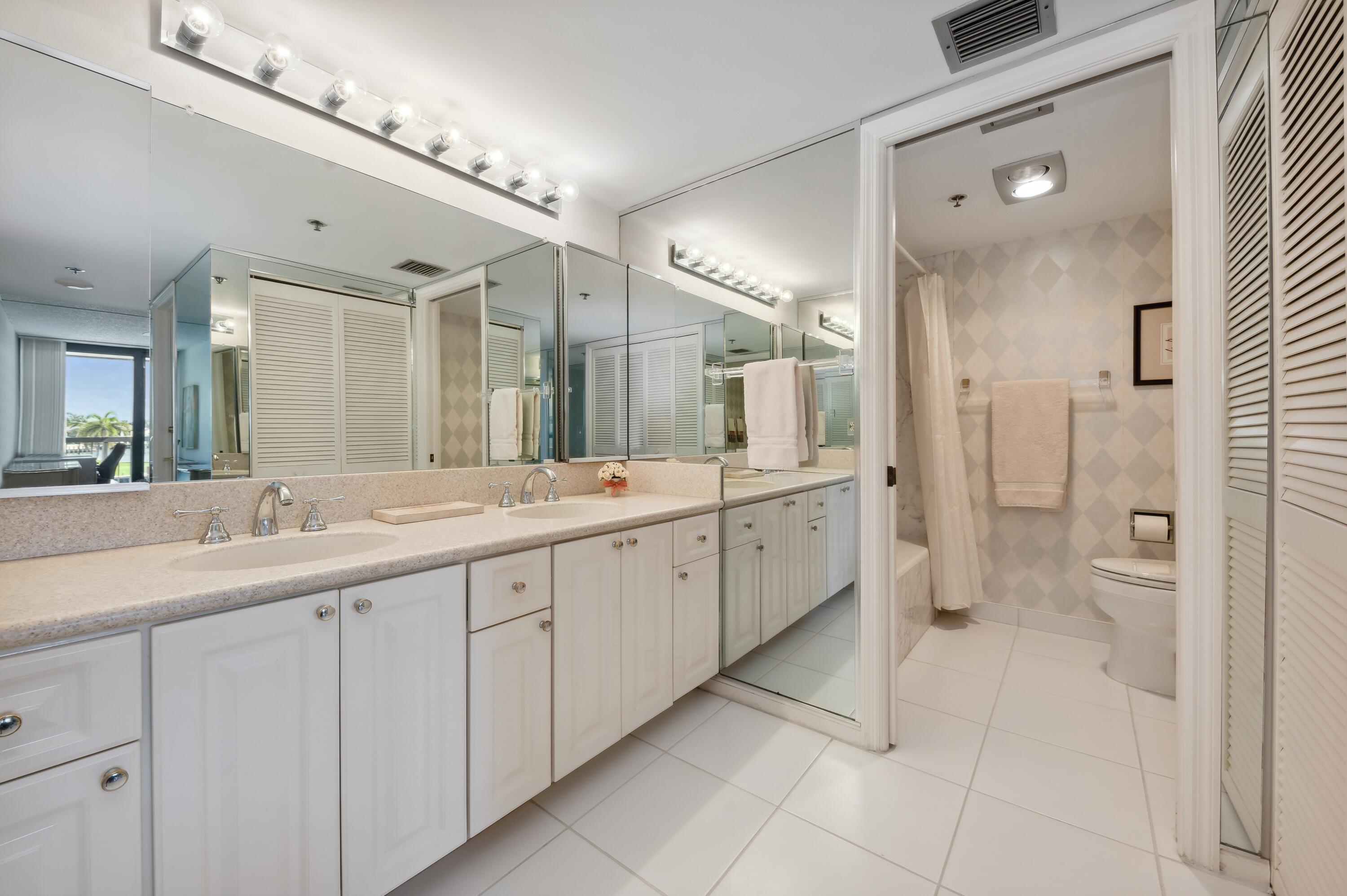 4748 South Ocean Boulevard, Unit 206 Highland Beach, FL 33487 - Photo 20 of 31 a spacious bathroom with a granite countertop sink mirror and a