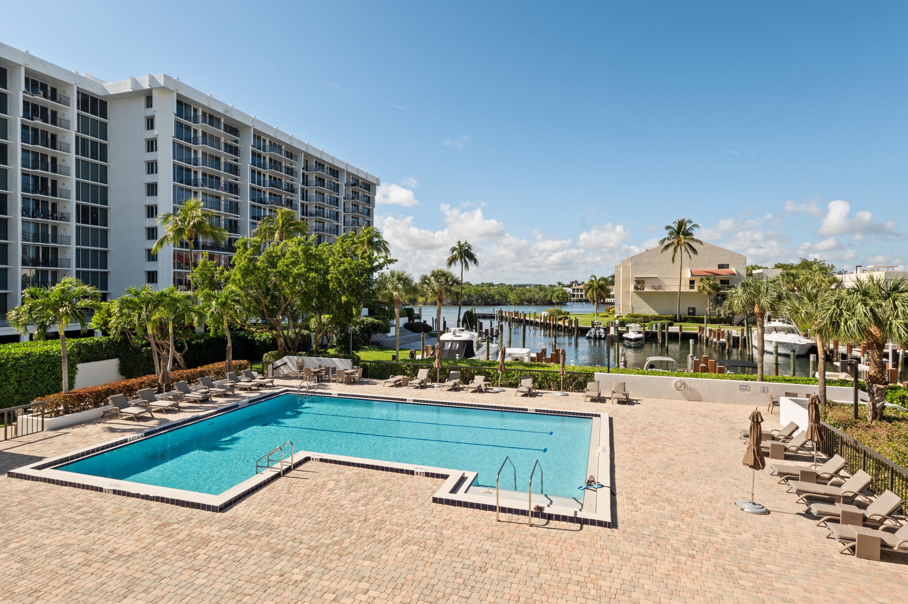 4748 South Ocean Boulevard, Unit 206 Highland Beach, FL 33487 - Photo 2 of 31 a view of a swimming pool with a lounge chair