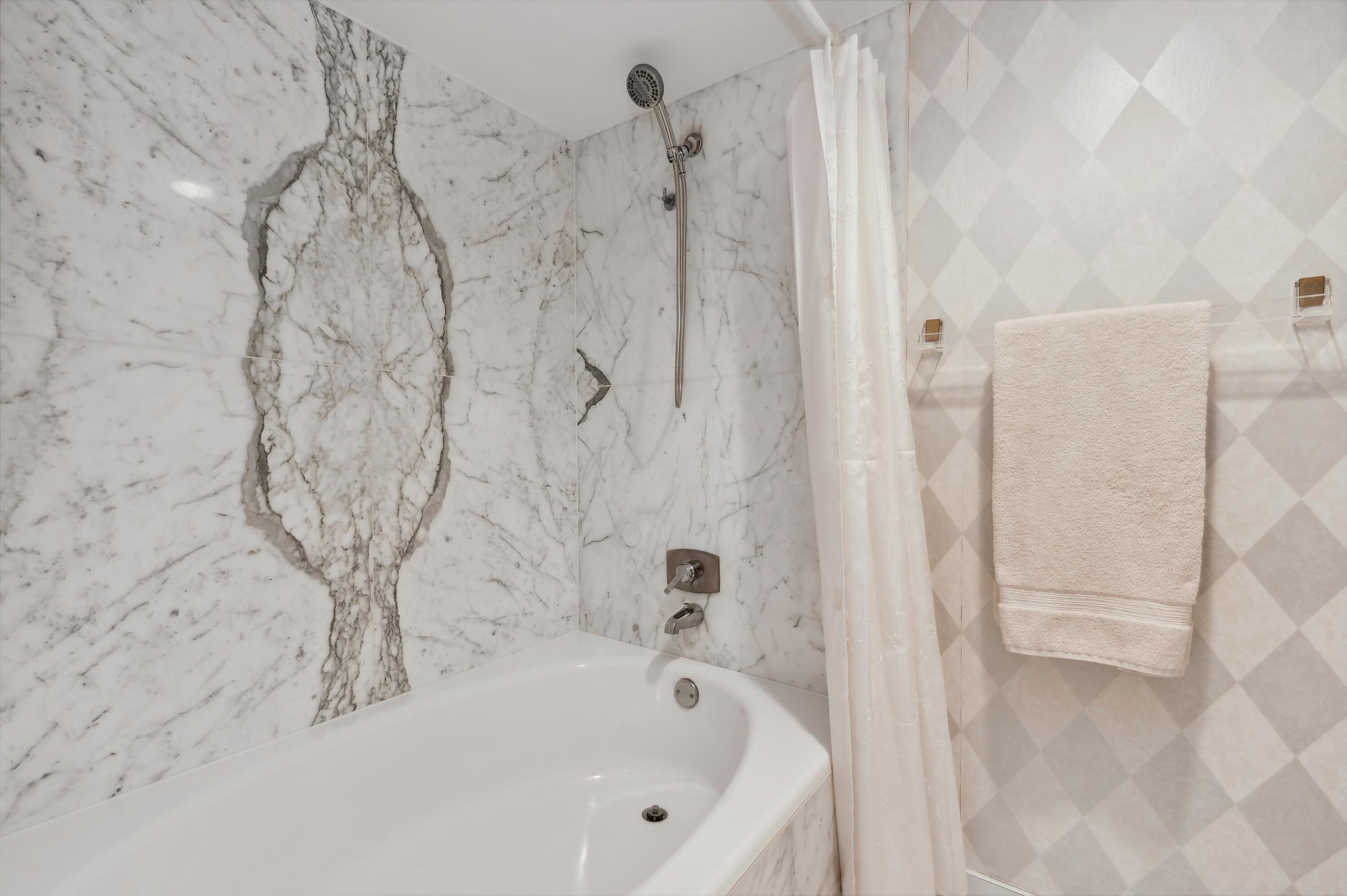 4748 South Ocean Boulevard, Unit 206 Highland Beach, FL 33487 - Photo 21 of 31 a bathroom with bathtub and shower