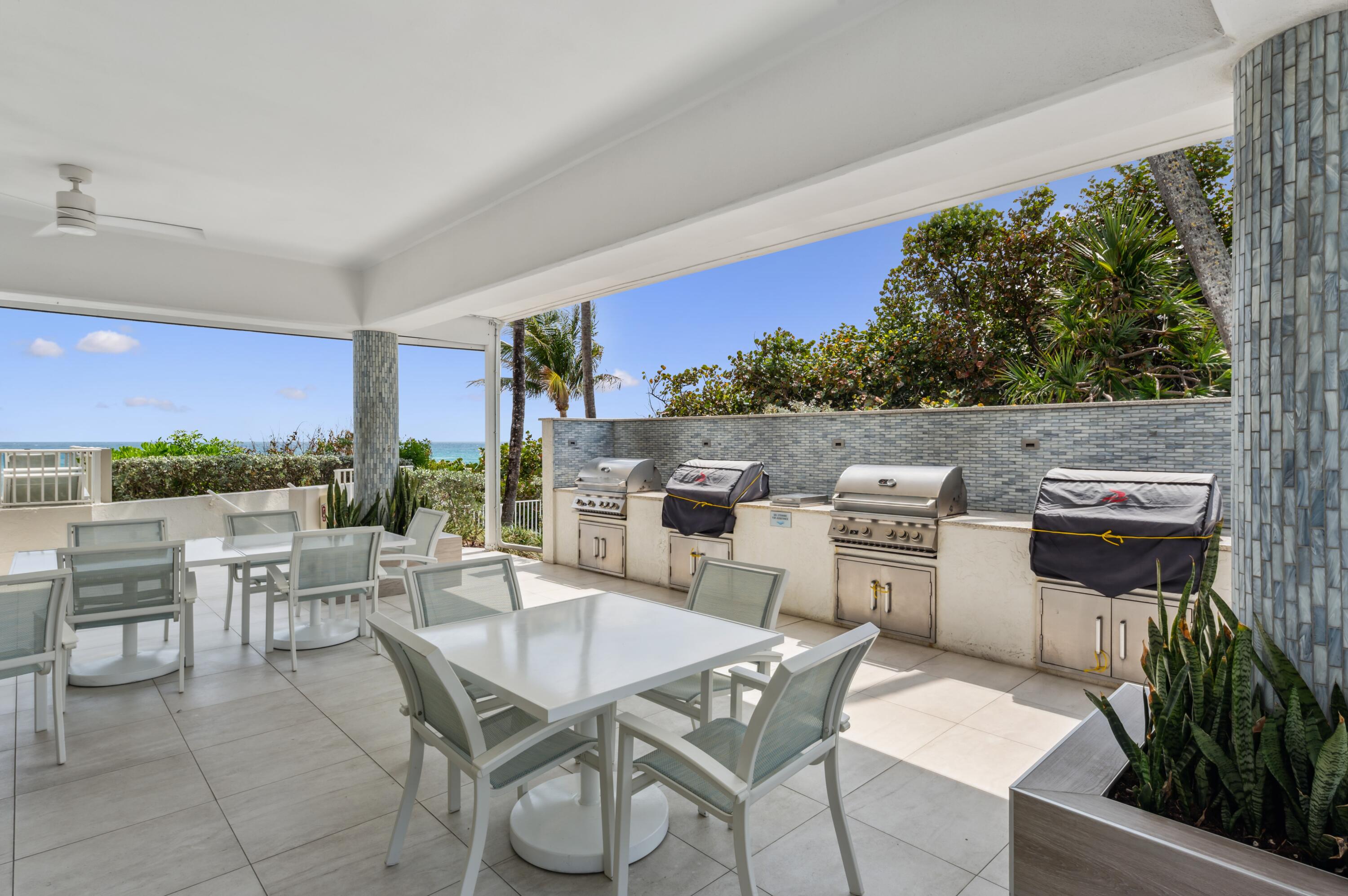 4748 South Ocean Boulevard, Unit 206 Highland Beach, FL 33487 - Photo 25 of 31 a dinning table and chairs in the terrace