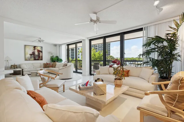 a large room with a lot of white furniture and couches