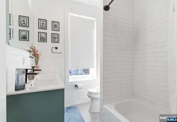 a bathroom with a sink a toilet and tub