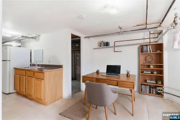 a view of kitchen with cabinets and window
