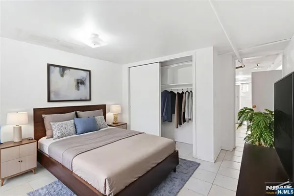 a bed room with a bed and a walk in closet