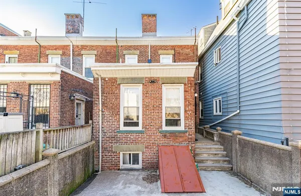 a view of a brick house with many windows