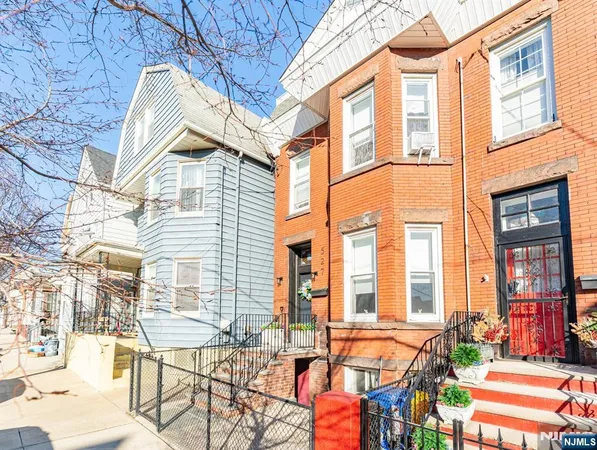 a view of a building from a chairs and table in the patio