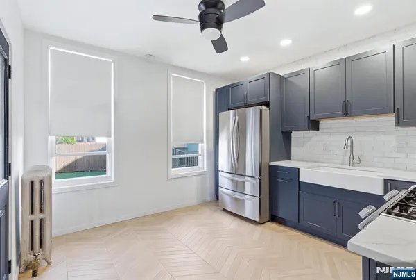 a kitchen with stainless steel appliances a refrigerator and a sink
