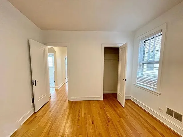 a view of a room with wooden floor and window