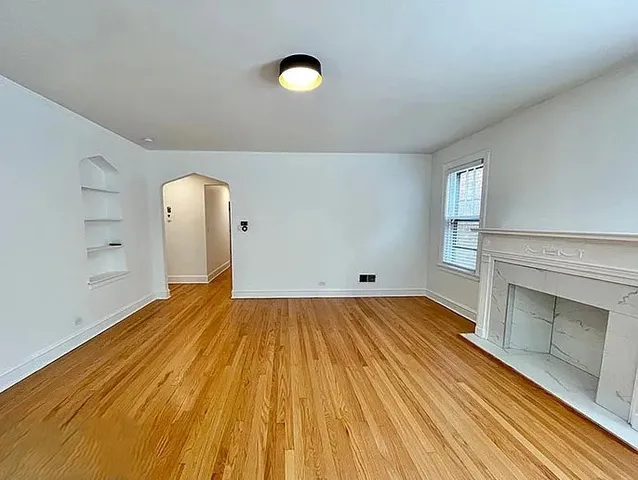 a view of a room with wooden floor and staircase