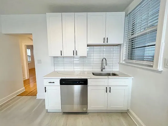 a kitchen with stainless steel appliances a sink stove and cabinets