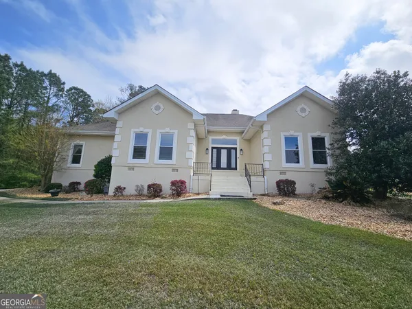 a front view of a house with a yard