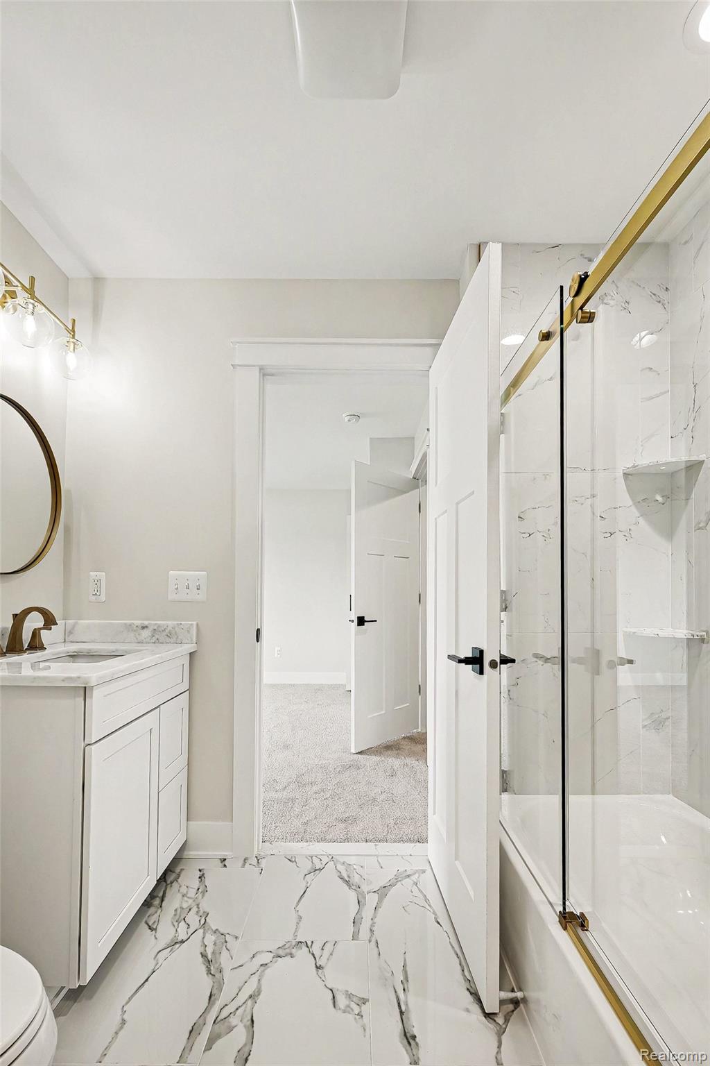 57560 Omo Road Ray, MI 48096 - Photo 34 of 44 Upper level en suite bathroom featuring a white vanity with a granite countertop, a rectangular undermount sink, and a gold-finish faucet