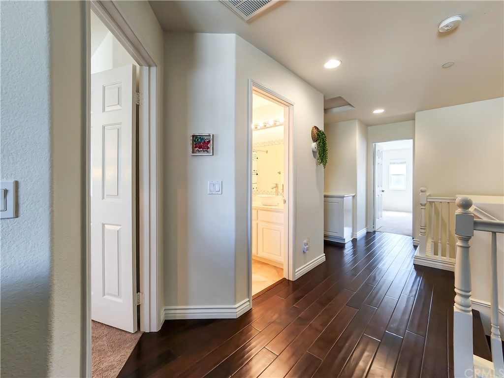 8024 Tulsa Place, Unit 107 Rancho Cucamonga, CA 91730 - Photo 16 of 35 a view of a hallway with wooden floor windows and a livingroom
