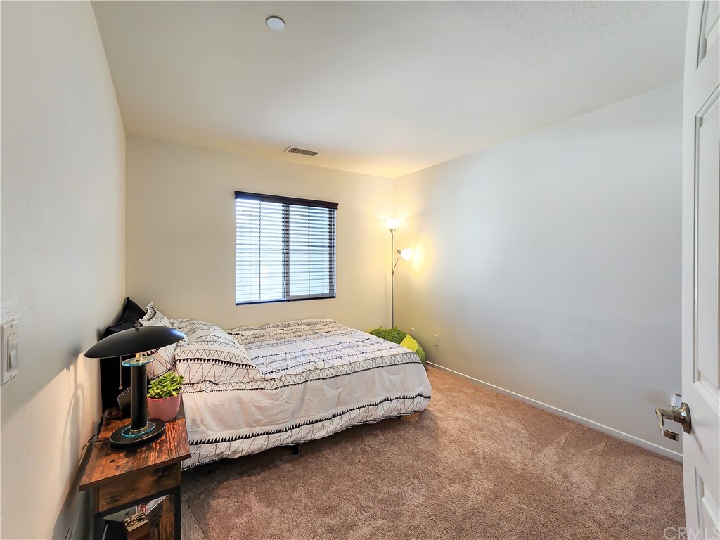 8024 Tulsa Place, Unit 107 Rancho Cucamonga, CA 91730 - Photo 17 of 35 a bedroom with a bed and a window