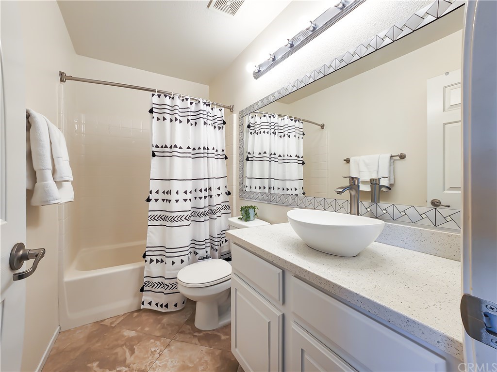 8024 Tulsa Place, Unit 107 Rancho Cucamonga, CA 91730 - Photo 19 of 35 a bathroom with a sink a toilet and shower