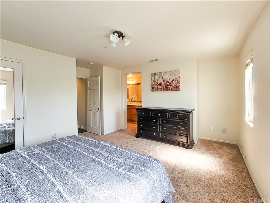 8024 Tulsa Place, Unit 107 Rancho Cucamonga, CA 91730 - Photo 21 of 35 a bedroom with a bed and a dresser