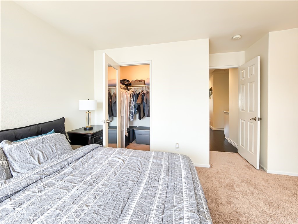 8024 Tulsa Place, Unit 107 Rancho Cucamonga, CA 91730 - Photo 22 of 35 a bedroom with a bed and a walk in closet