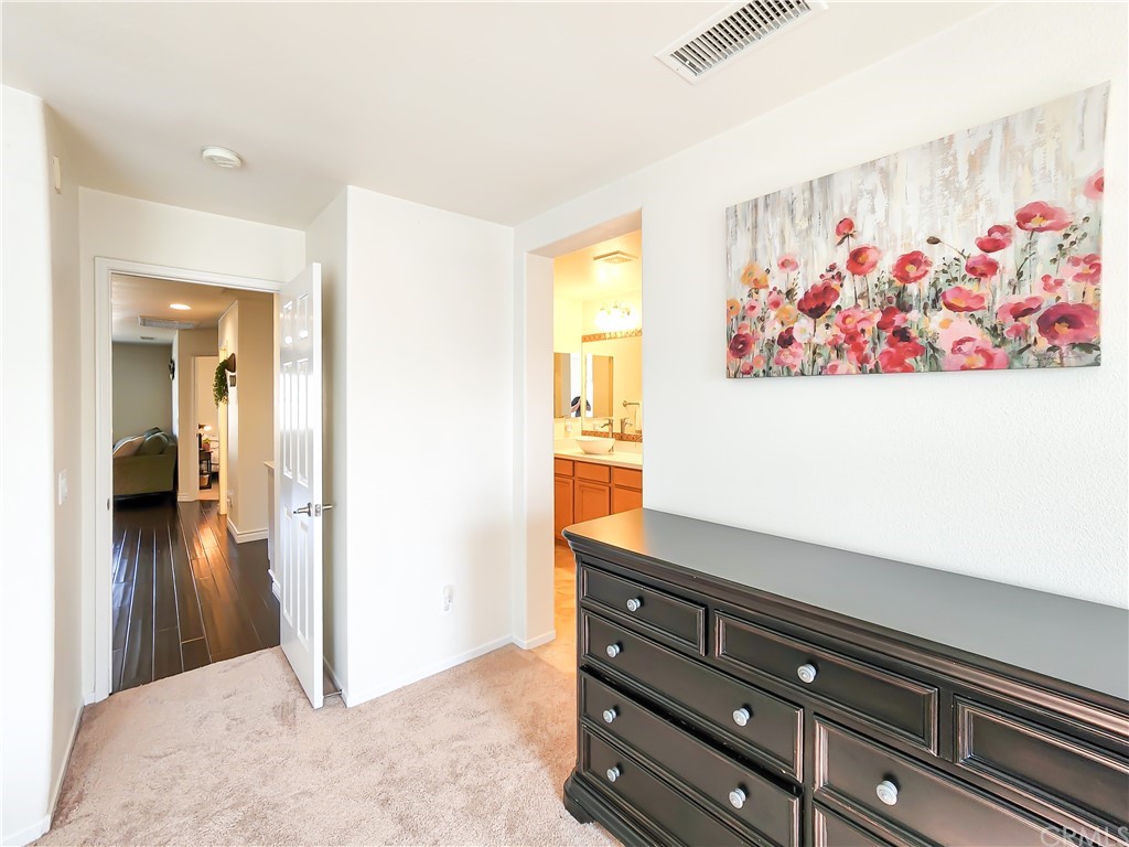 8024 Tulsa Place, Unit 107 Rancho Cucamonga, CA 91730 - Photo 23 of 35 a view of painting on the wall and a potted plant