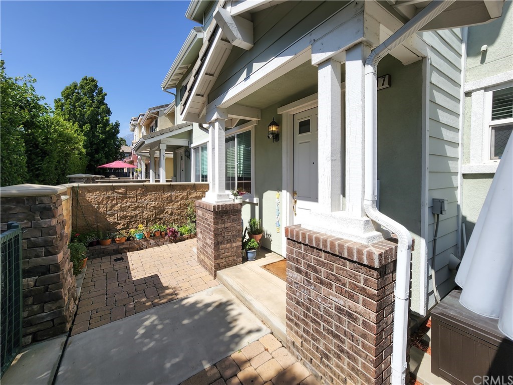 8024 Tulsa Place, Unit 107 Rancho Cucamonga, CA 91730 - Photo 26 of 35 a view of a patio with table and chairs and wooden fence