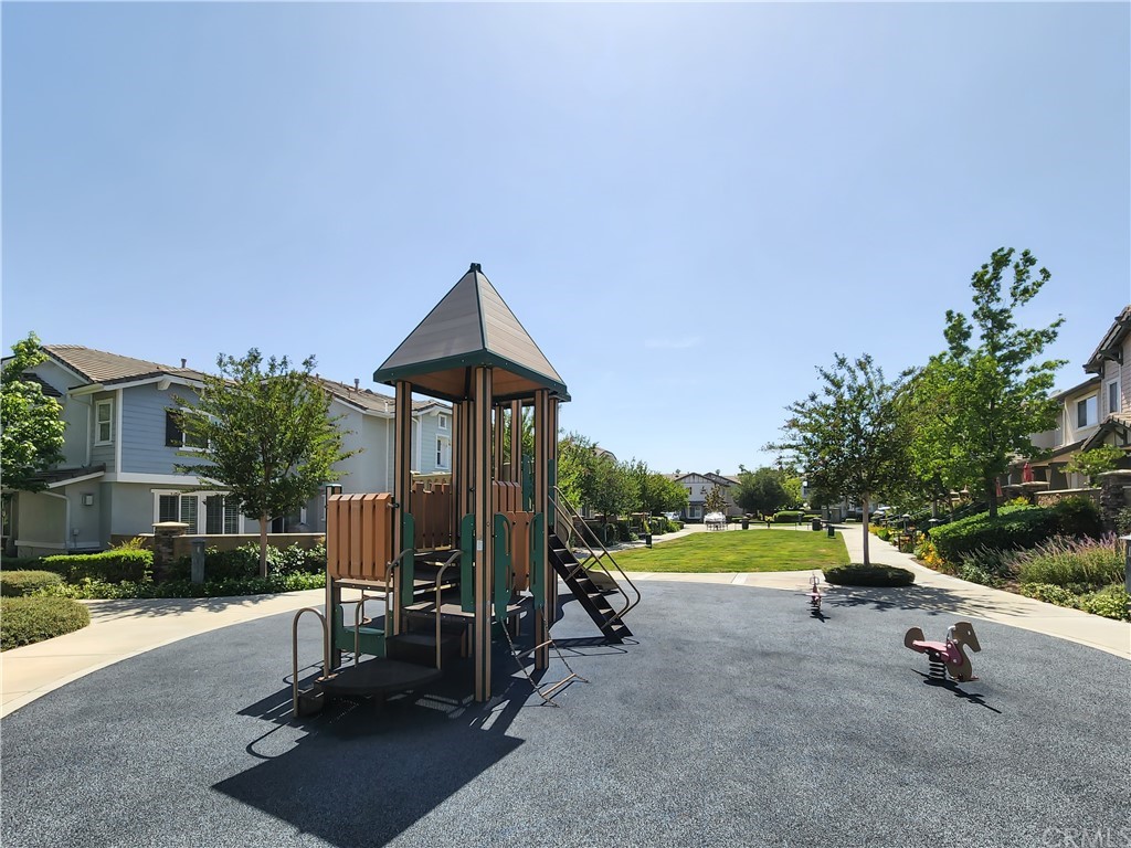 8024 Tulsa Place, Unit 107 Rancho Cucamonga, CA 91730 - Photo 28 of 35 a view of a park with slide and table