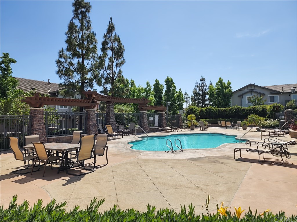 8024 Tulsa Place, Unit 107 Rancho Cucamonga, CA 91730 - Photo 29 of 35 a view of backyard with swimming pool and outdoor seating