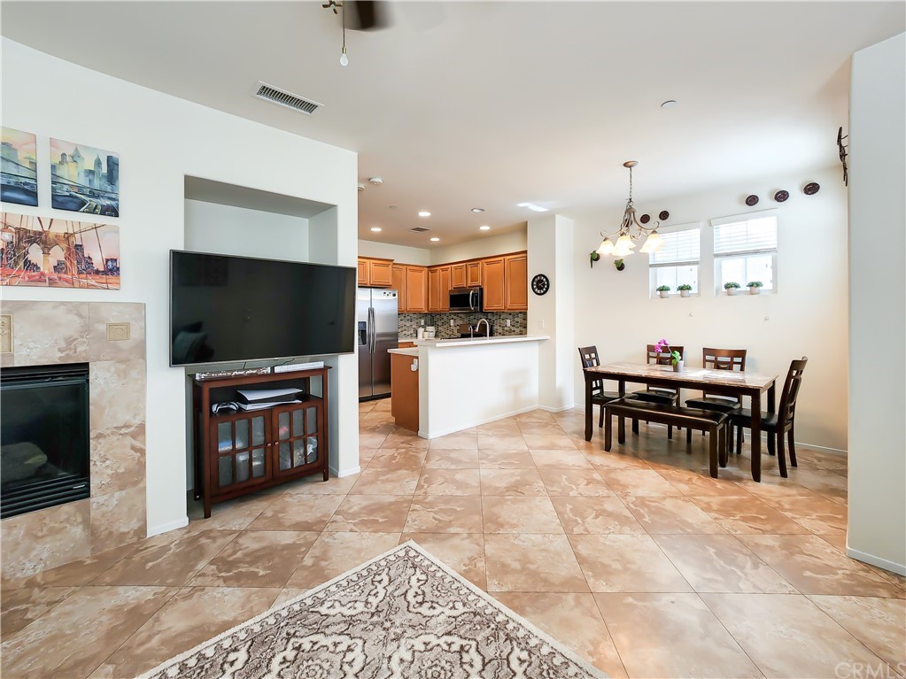 8024 Tulsa Place, Unit 107 Rancho Cucamonga, CA 91730 - Photo 5 of 35 a living room with furniture and a flat screen tv